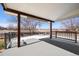 Covered back porch with ceiling heaters and view of the neighboring field at 2451 S Fenton Dr, Lakewood, CO 80227