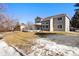 Beautiful backyard with large deck, spacious lawn, and a view of mature trees at 2451 S Fenton Dr, Lakewood, CO 80227