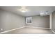 Finished basement with tiled flooring and a window for natural light at 2451 S Fenton Dr, Lakewood, CO 80227