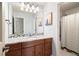 Bright bathroom featuring a granite countertop vanity, art deco, and a shower-tub combo at 2451 S Fenton Dr, Lakewood, CO 80227