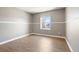 Cozy bedroom featuring a window with backyard view, neutral paint, and wood floors at 2451 S Fenton Dr, Lakewood, CO 80227