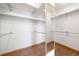 Walk-in closet features wood floors, white walls, shelving and a full length mirror at 2451 S Fenton Dr, Lakewood, CO 80227