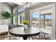 Bright dining area features a modern chandelier, a round table, and sliding glass doors to the patio at 2451 S Fenton Dr, Lakewood, CO 80227