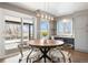 Dining room featuring a unique lighting fixture, access to a balcony, and an adjacent desk area at 2451 S Fenton Dr, Lakewood, CO 80227