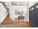 Grand foyer with hardwood floors, staircase, and a view of the dining room with elegant chandelier at 2451 S Fenton Dr, Lakewood, CO 80227