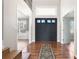 Inviting foyer featuring hardwood floors, a decorative rug, and a view into adjacent living spaces at 2451 S Fenton Dr, Lakewood, CO 80227