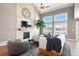 Inviting living room with vaulted ceiling, stone fireplace, large windows, and stylish decor at 2451 S Fenton Dr, Lakewood, CO 80227