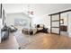 Well-lit main bedroom with a ceiling fan, a window, a sliding barn door, and stylish décor at 2451 S Fenton Dr, Lakewood, CO 80227