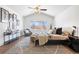 Vaulted main bedroom features a ceiling fan, a large window, and stylish decor at 2451 S Fenton Dr, Lakewood, CO 80227