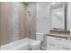 Well-lit bathroom with combined tub and shower, mosaic tiling accents, and sleek fixtures at 1284 Tennyson St # 1, Denver, CO 80204