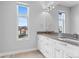 Modern bathroom with double sink vanity, streamlined cabinets, and a large window providing natural light at 1284 Tennyson St # 1, Denver, CO 80204