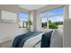 Bright bedroom featuring large windows offering outside views and a comfortable bed with blue decorative pillows at 1284 Tennyson St # 1, Denver, CO 80204