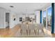 Dining area open to the kitchen with hardwood floors and balcony access at 1284 Tennyson St # 1, Denver, CO 80204