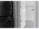 A modern stacked washer and dryer set featured near a doorway of the home at 1284 Tennyson St # 1, Denver, CO 80204