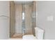 Modern shower with glass door, tiled walls, and mosaic accents at 1284 Tennyson St # 1, Denver, CO 80204