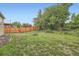 Large backyard with ample grass area and a wood privacy fence at 10441 Routt Ln, Broomfield, CO 80021