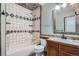 Bathroom showcasing tiled walls, tub and shower combination, and modern fixtures at 10441 Routt Ln, Broomfield, CO 80021