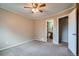 Bedroom featuring neutral walls, plush carpet, ceiling fan, and an ensuite bathroom at 10441 Routt Ln, Broomfield, CO 80021