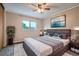 Inviting bedroom with a ceiling fan, large window, and neutral walls at 10441 Routt Ln, Broomfield, CO 80021