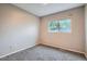 Bedroom featuring neutral walls, carpet, and a view to the backyard at 10441 Routt Ln, Broomfield, CO 80021