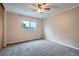 Neutral Primary bedroom with a ceiling fan, large window, and plush carpet at 10441 Routt Ln, Broomfield, CO 80021