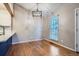 Bright dining area with hardwood floors, modern light fixture, and adjacent access to the kitchen at 10441 Routt Ln, Broomfield, CO 80021