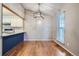 Dining area showcasing hardwood floors, a modern light fixture, and pass-through to the adjacent kitchen at 10441 Routt Ln, Broomfield, CO 80021