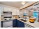 Bright kitchen with white cabinets and white appliances at 10441 Routt Ln, Broomfield, CO 80021