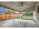 Covered patio with a fan, concrete flooring, and views of the fenced backyard at 10441 Routt Ln, Broomfield, CO 80021