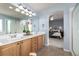 Main bathroom features double vanity and a view into the bedroom at 8445 Braun Loop, Arvada, CO 80005