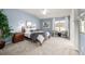 Main bedroom with light blue walls, ceiling fan, and comfortable seating at 8445 Braun Loop, Arvada, CO 80005