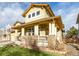 Two-story house with a wrap-around porch and stone accents at 8445 Braun Loop, Arvada, CO 80005