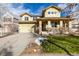 Two-story house with a front porch and landscaped yard at 8445 Braun Loop, Arvada, CO 80005