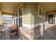 Front porch with stone and wood details, and a bench at 8445 Braun Loop, Arvada, CO 80005