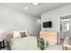 A cozy bedroom features light-colored walls and a wooden dresser with a TV mounted above at 1941 Hooker St, Denver, CO 80204