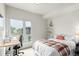 A comfortable bedroom features a large window, desk, and a cozy bed with a decorative blanket at 1941 Hooker St, Denver, CO 80204
