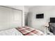 This bedroom is equipped with a desk, TV, and closet offering a seamless blend of comfort and function at 1941 Hooker St, Denver, CO 80204