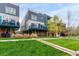 Stylish townhome with a blue balcony, well-maintained landscaping, and a lush green lawn, creating a welcoming exterior at 1941 Hooker St, Denver, CO 80204