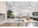 Open-concept living space with a modern kitchen featuring a breakfast bar and a living room with a fireplace and stylish decor at 1941 Hooker St, Denver, CO 80204