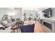 Bright living room boasts a cozy fireplace, modern furniture, dining space, and large windows for ample natural light at 1941 Hooker St, Denver, CO 80204
