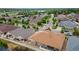 Aerial view of a residential neighborhood showcasing the landscape and home with brown roof, backyard, and partial privacy fence at 4400 S Ensenada St, Aurora, CO 80015