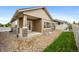 Cozy backyard patio with rock landscaping, green grass, and partial fence for privacy, perfect for outdoor relaxation at 4400 S Ensenada St, Aurora, CO 80015