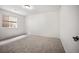 A cozy bedroom provides carpet, neutral walls, and a window for natural light at 4400 S Ensenada St, Aurora, CO 80015