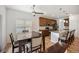 Connected dining area with modern light fixture, hardwood floors, and natural light from window at 4400 S Ensenada St, Aurora, CO 80015