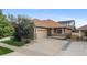 Charming single-Gathering home featuring a two-car garage, stone accents, and a covered porch at 4400 S Ensenada St, Aurora, CO 80015