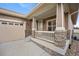 Close-up of the front porch of a brown home with stone accents and a two car garage at 4400 S Ensenada St, Aurora, CO 80015