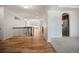 Open hallway features hardwood floors leading to the kitchen and dining area at 4400 S Ensenada St, Aurora, CO 80015