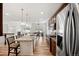 Open-concept kitchen featuring a large island with granite countertops and stainless steel appliances at 4400 S Ensenada St, Aurora, CO 80015