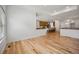 Bright living room featuring hardwood floors and an open layout to the kitchen at 4400 S Ensenada St, Aurora, CO 80015