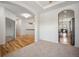Open living space with hardwood and carpeted floors, arches and neutral tones at 4400 S Ensenada St, Aurora, CO 80015